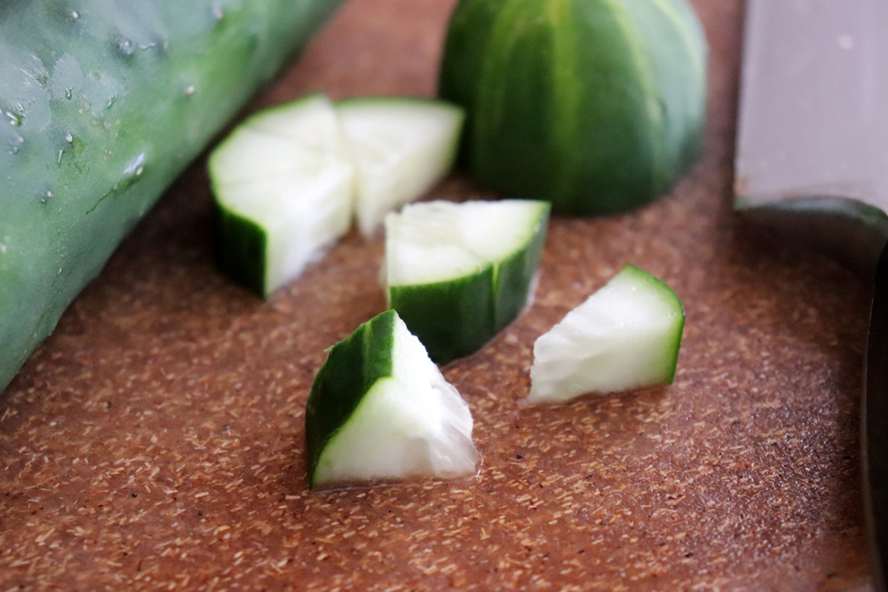 Cut cucumber for Watermelon and Goat Cheese Appetizers