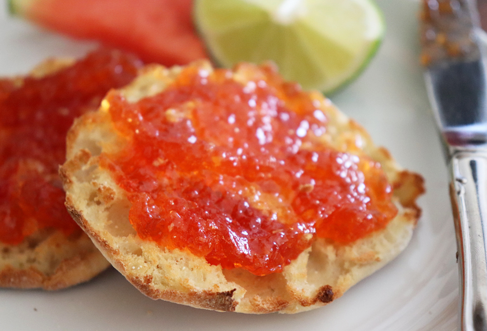 Easy Watermelon Jam Recipe spread on a muffin